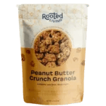 A bag of Rooted Living Peanut Butter Crunch Granola with an image of granola pieces on the front.